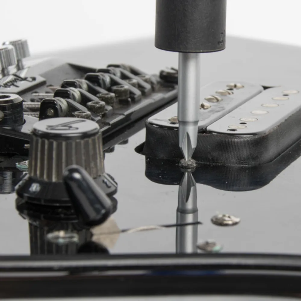 Adjust by raising or lowering guitar pickups like this fender strat