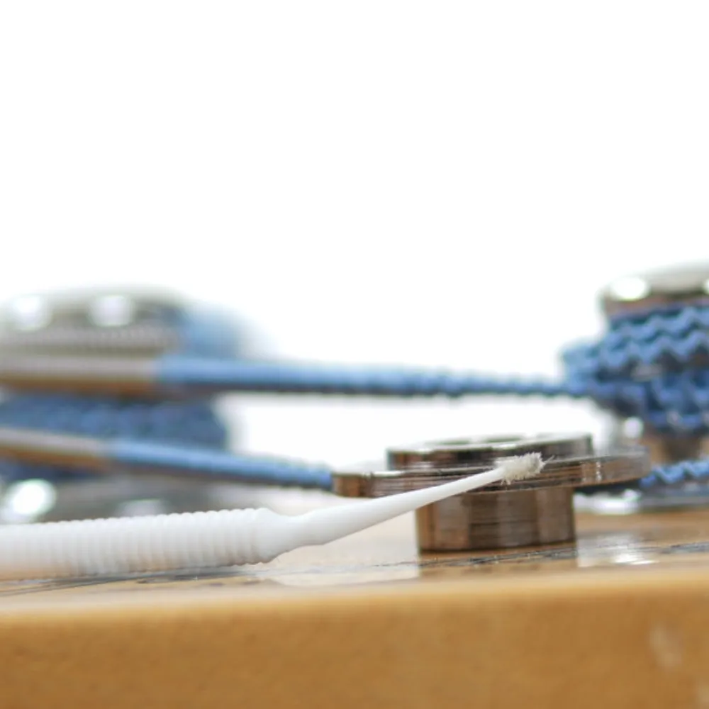 Applicator can bend for hard to reach areas such as string guides