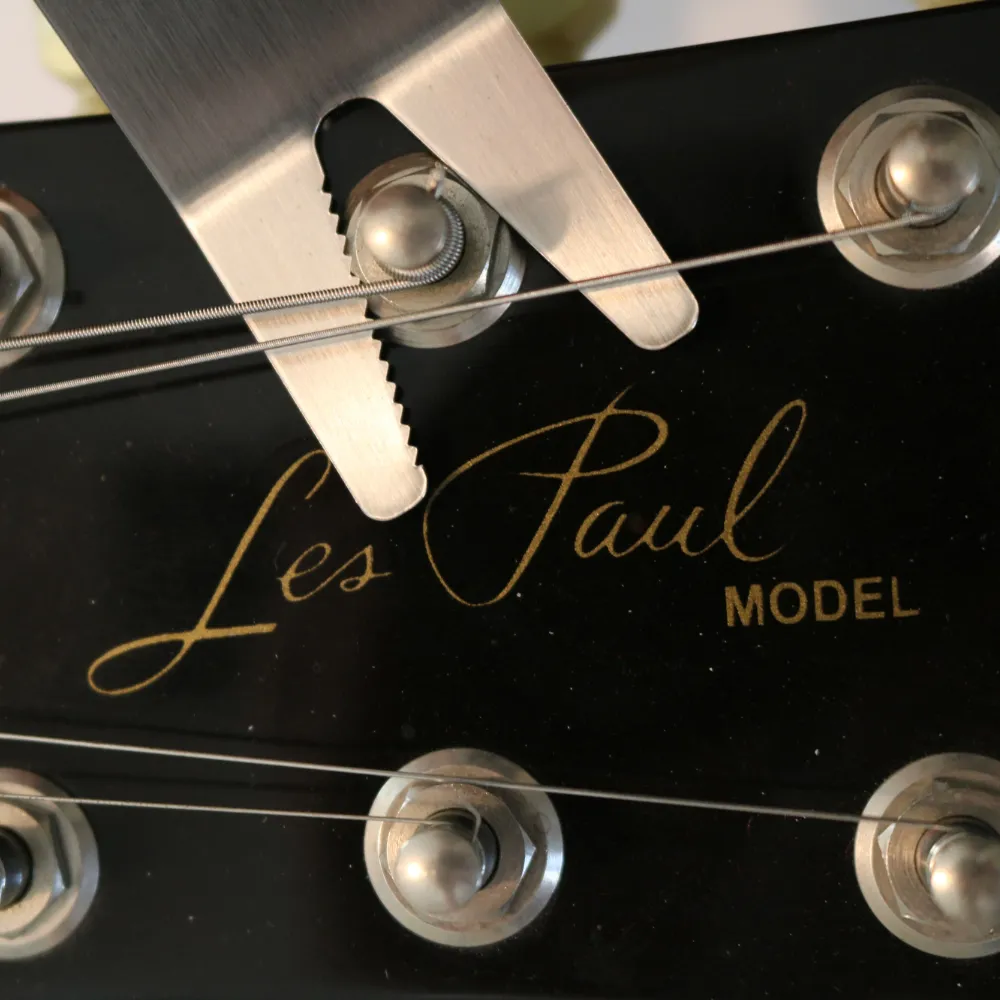 Tighten tuners when strings are on